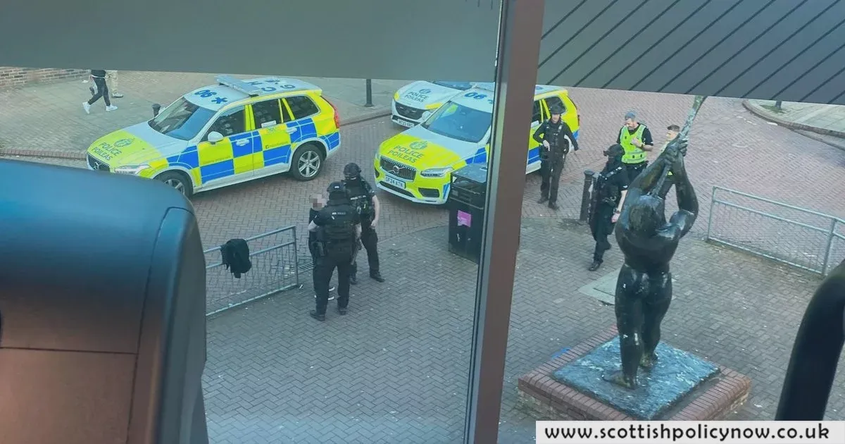 Heavy Police Presence at Scottish Gym, Picture Shows Man in Handcuffs – 100 Character Title